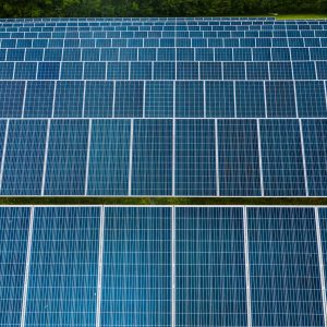 Contemporary installation of solar panels mounted on field in environmental friendly solar power station